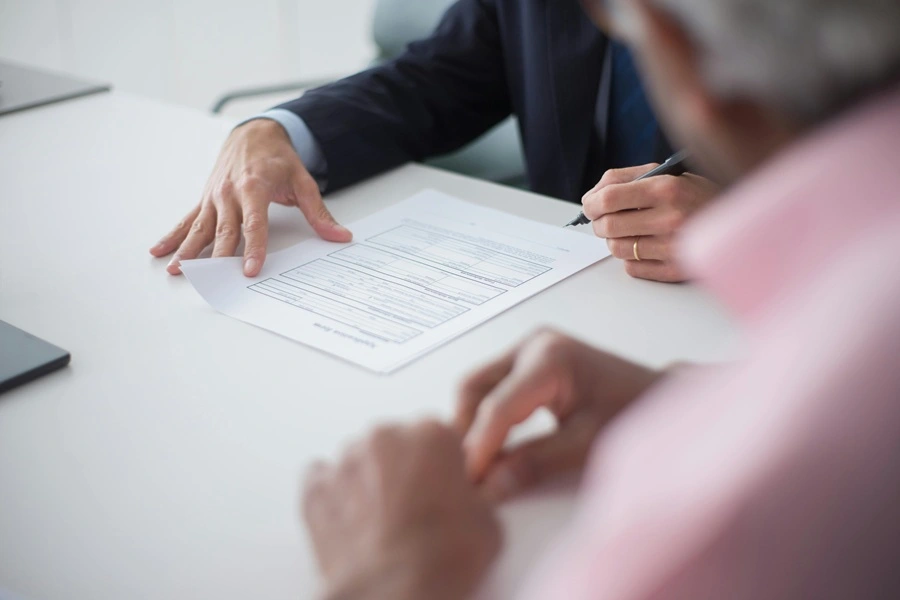 A lawyer and client reviewing legal documents during a professional consultation in a law office.