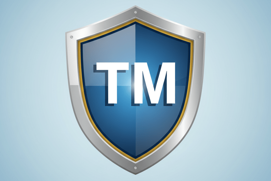 A blue metallic shield icon featuring the letters 'TM' in the center, representing trademark protection